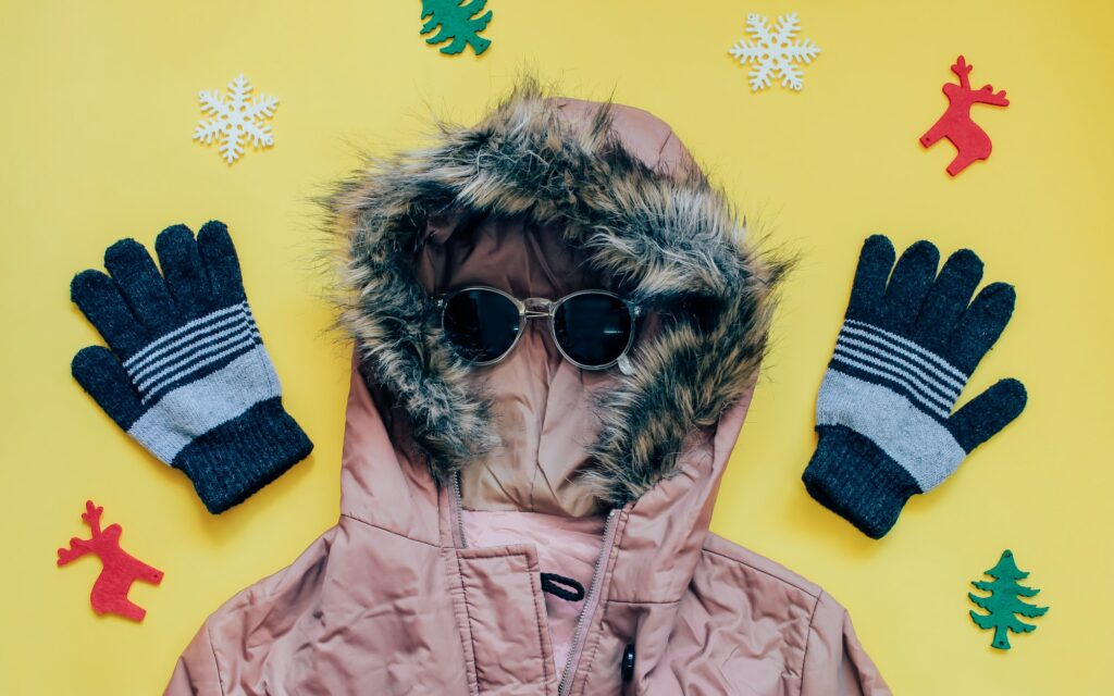 Creative flat lay of winter clothes with jacket